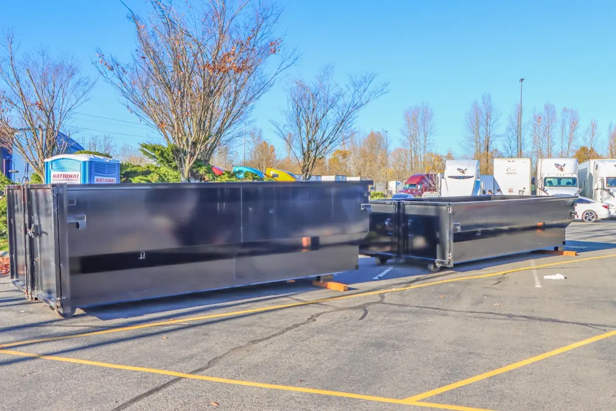 Professional dumpster rental service with roll-off container on residential driveway in Homewood